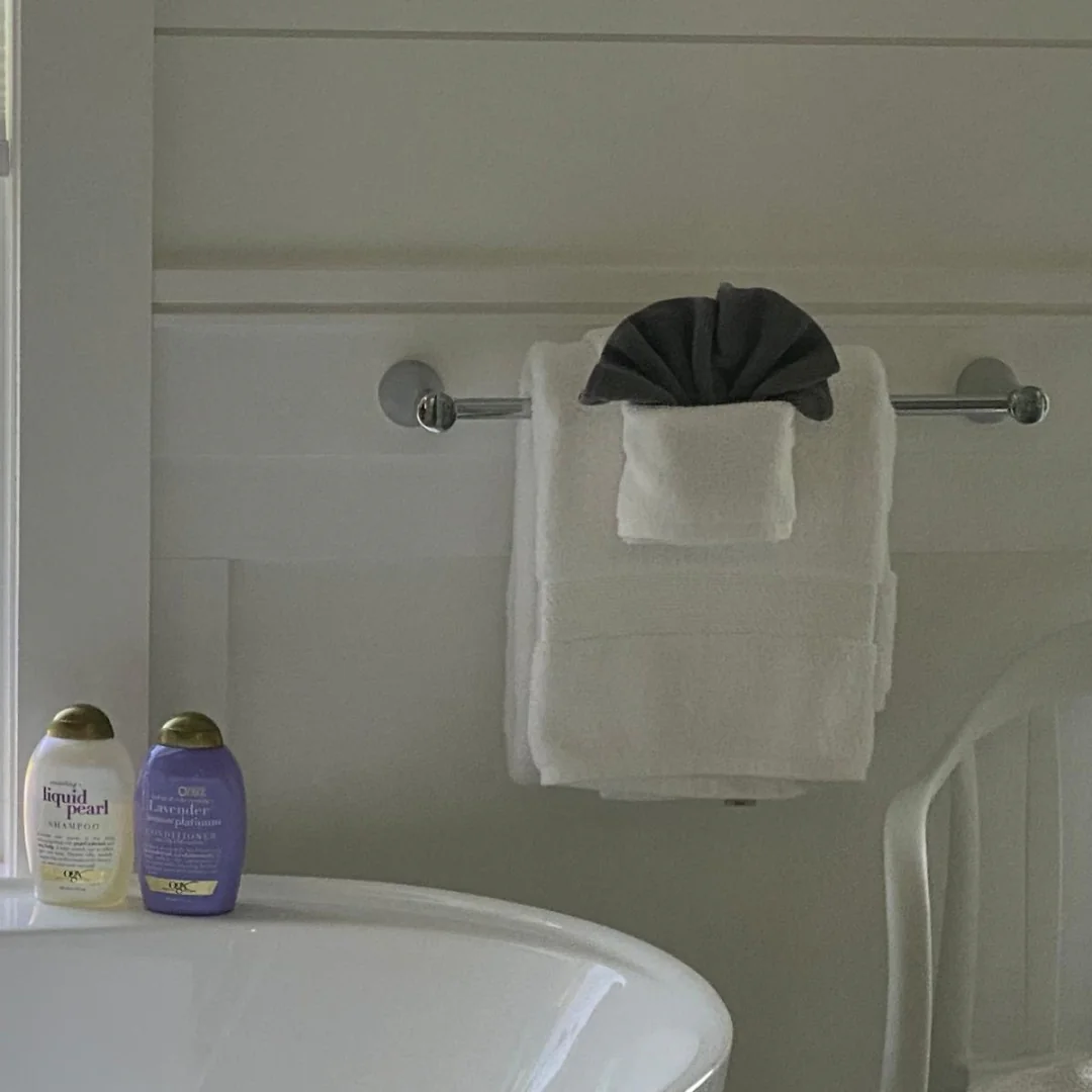 Bathroom with freshly folded towels and polished fixtures after a Sentinel cleaning