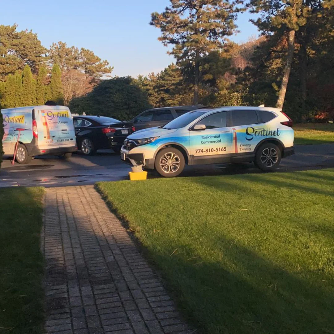 Sentinel Cleaning Company vans parked at a Cape Cod second home for a seasonal cleaning