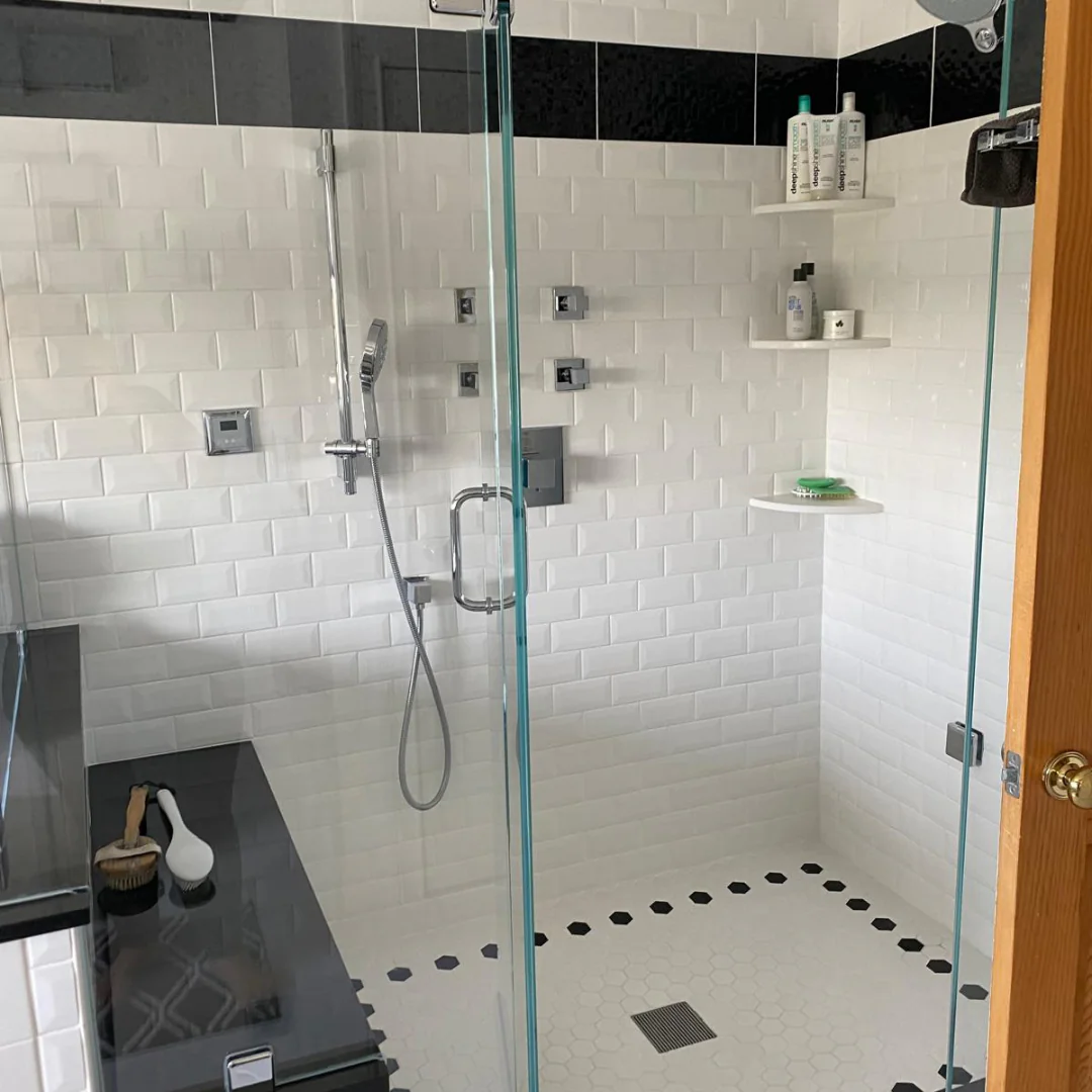 Walk in glass shower with white subway tile cleaned streak free by Sentinel