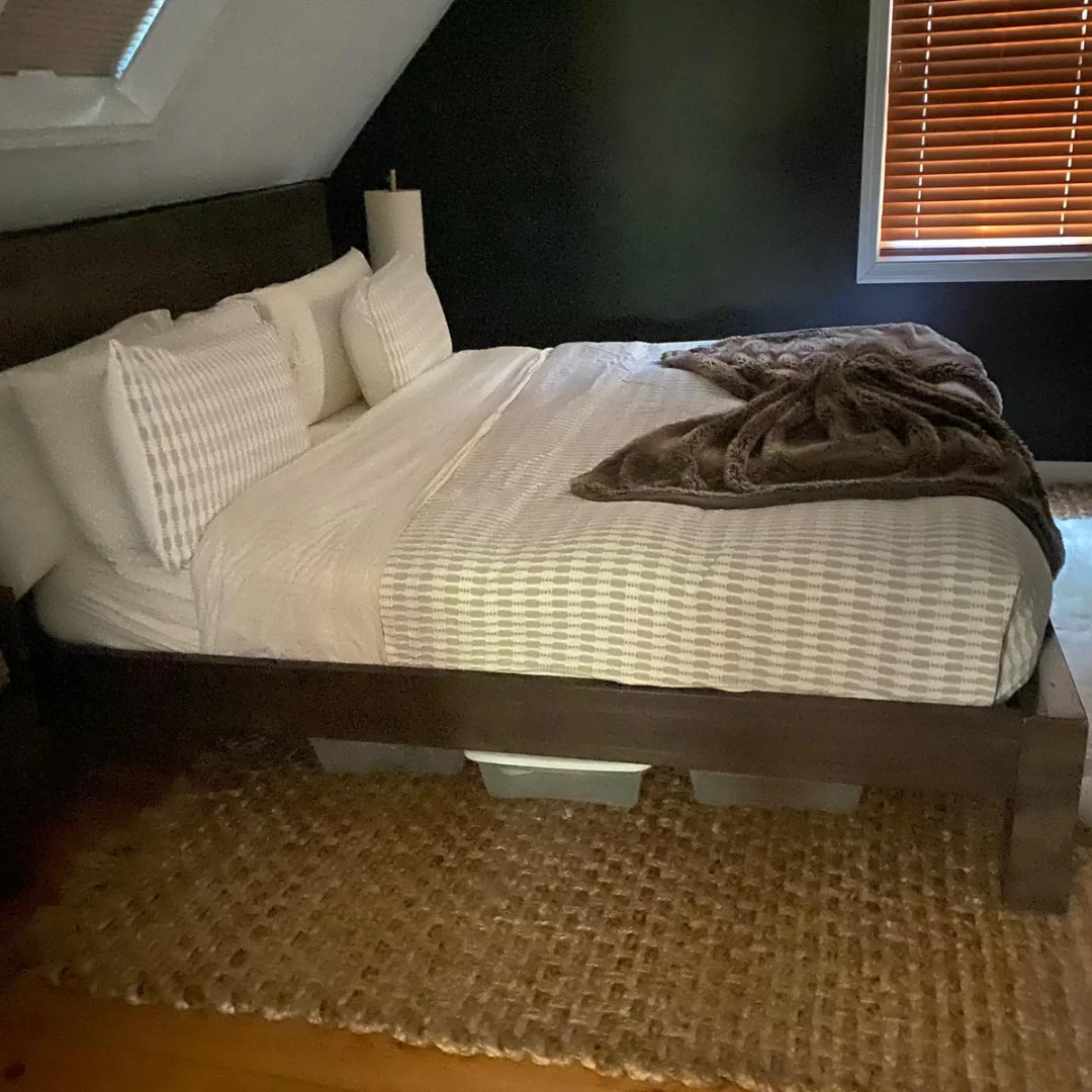 Primary bedroom with white bedding and jute rug after recurring house cleaning on Cape Cod